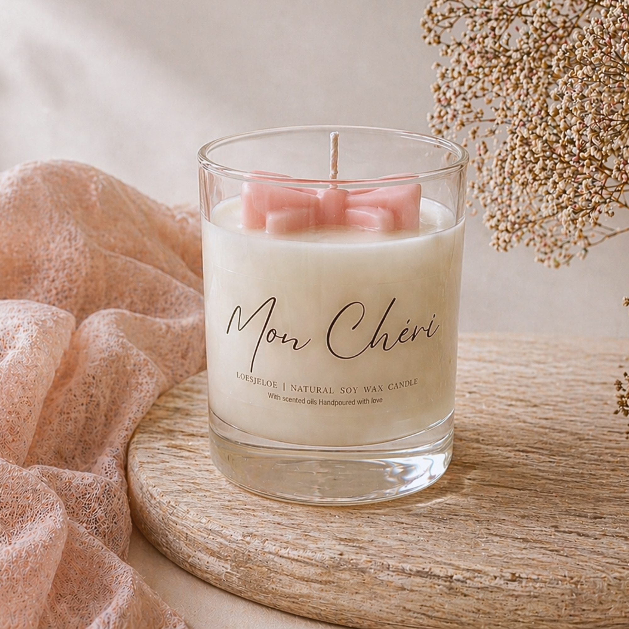 Mon Cheri Bow Candle made from natural soy wax with a pink wax bow and sweet cherry vanilla scent.