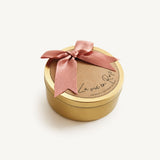 La Vie en Rose Golden Floral Candle van natuurlijke sojawas in gouden candle tin met roze strik en zachte bloemige geur. La Vie en Rose Golden Floral Candle made from natural soy wax in a golden candle tin with a soft pink bow and soft floral scent.

